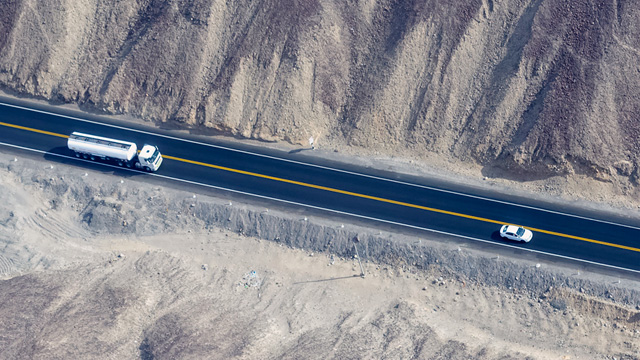 A truck and a small car on the road