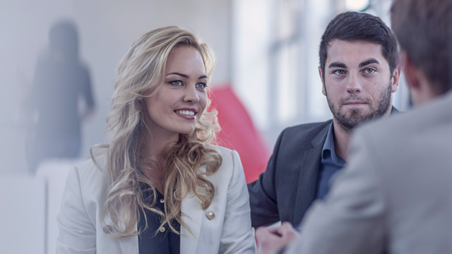 A couple meeting a bank advisor in an office